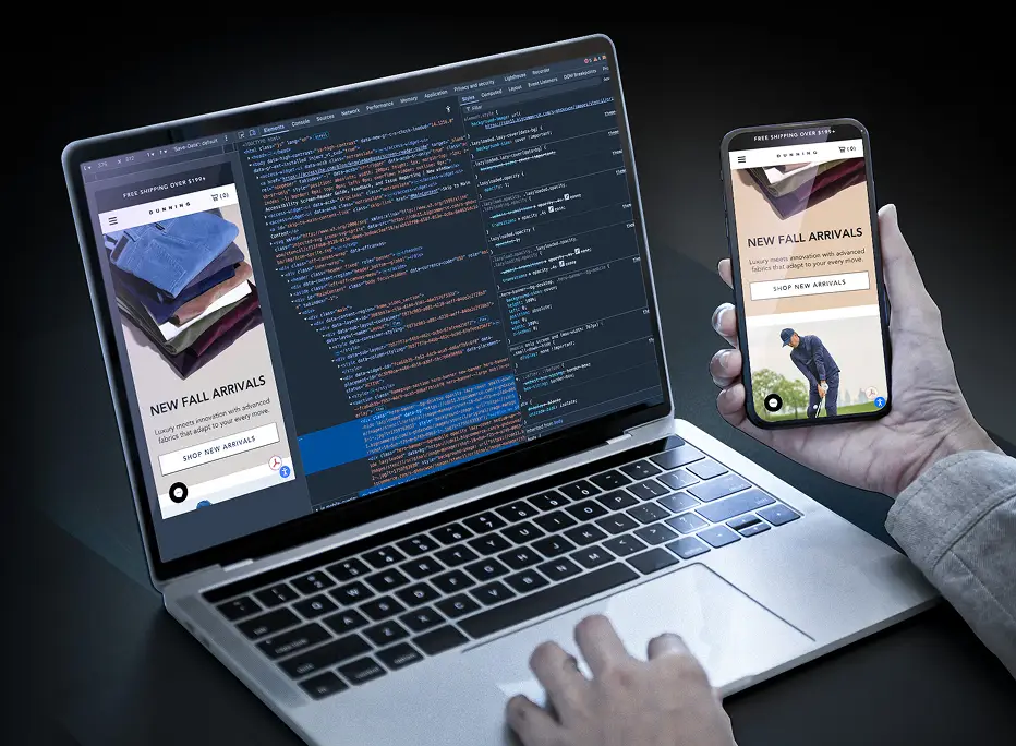 A person working on a laptop displaying website code and a mobile phone showing the same website’s product page, demonstrating responsive web design and development.