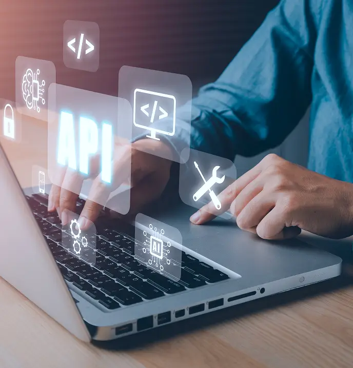 <p>Hands typing on a laptop keyboard with floating digital icons representing API development, including symbols for coding, tools, security, and artificial intelligence.</p>