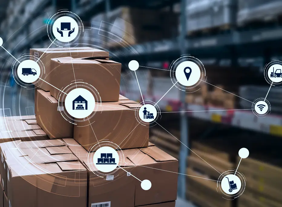 A stack of cardboard shipping boxes in a warehouse with a digital overlay showing interconnected logistics icons, including a delivery truck, warehouse, location pin, forklift, Wi-Fi, and supply chain symbols, representing smart or connected inventory and distribution systems.