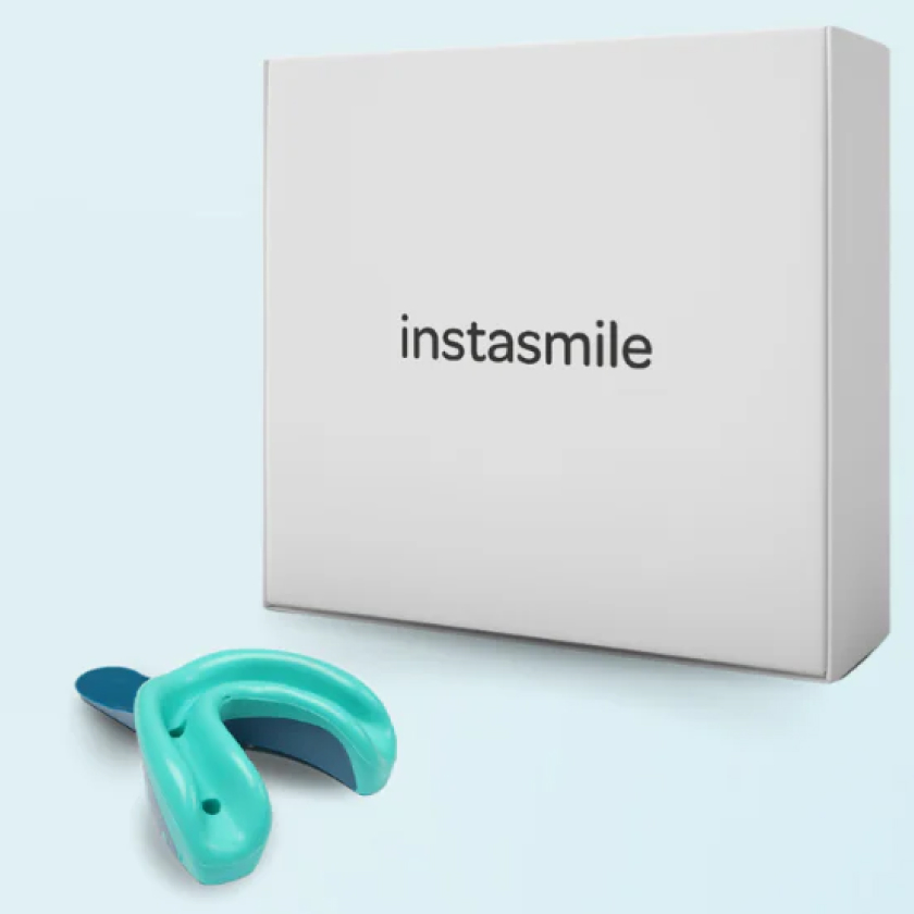 Instasmile white box and green dental impression tray on a light blue background, representing the at-home smile kit.